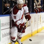 Phoenix Coyotes' Shane Doan dumps the puck into the Tampa Bay Lightning's end during the first period of an NHL hockey game Wednesday, Feb. 23, 2011, in Tampa, Fla. Doan was playing in his 1,099th game with the Winnipeg/Phoenix franchise. (AP Photo/Mike Carlson)