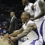 Washington guard Isaiah Thomas, bottom, Washington forward Darnell Gant, center and Washington forward Matthew Bryan-Amaning, top left, react to a goal in the last minutes of in the second half of a East Regional NCAA tournament second round college basketball game after the game, Friday, March 18, 2011, in Charlotte, N.C. (AP Photo/Bob Leverone)