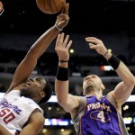 Los Angeles Clippers forward Ike Diogu (50) and Phoenix Suns center Marcin Gortat (4), of Poland, fight for a rebound in the first half of an NBA basketball game, Sunday, March 20, 2011, in Los Angeles.(AP Photo/Gus Ruelas)