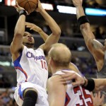 Los Angeles Clippers guard Eric Gordon (10) shoots for a basket as teammate Los Angeles Clippers center Chris Kaman (35) provides the screen in the first half of an NBA basketball game against the Phoenix Suns, Sunday, March 20, 2011, in Los Angeles. The Suns won 108-99. (AP Photo/Gus Ruelas)