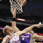 Los Angeles Clippers center Chris Kaman (35) and Phoenix Suns center Marcin Gortat (4), of Poland, fight for a rebound in the second half of an NBA basketball game, Sunday, March 20, 2011, in Los Angeles. The Suns won 108-99. (AP Photo/Gus Ruelas)