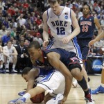 Duke's Seth Curry, bottom, and Arizona's Derrick Williams (23) scramble for the ball as Duke's Kyle Singler (12) looks on during the first half of a West regional semifinal in the NCAA college basketball tournament Thursday, March 24, 2011, in Anaheim, Calif. (AP Photo/Jae C. Hong)