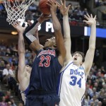 Arizona's Derrick Williams (23) shoots against Duke's Kyle Singler and Ryan Kelly (34) during the first half of a West regional semifinal in the NCAA college basketball tournament Thursday, March 24, 2011, in Anaheim, Calif. (AP Photo/Jae C. Hong)
