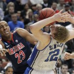 Duke's Kyle Singler (12) battles for a loose ball with Arizona's Derrick Williams (23) during the first half of a West regional semifinal in the NCAA college basketball tournament Thursday, March 24, 2011, in Anaheim, Calif. (AP Photo/Jae C. Hong)