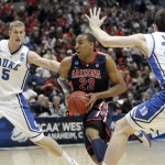 Arizona's Derrick Williams (23) drives between Duke's Mason Plumlee (5) and Ryan Kelly (34) during the first half of a West regional semifinal in the NCAA college basketball tournament Thursday, March 24, 2011, in Anaheim, Calif. (AP Photo/Jae C. Hong)