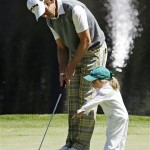 Aaron Baddeley of Australia's daughter Jewel points at his ball before his putt on the ninth hole during the Par 3 competition before the Masters golf tournament Wednesday, April 6, 2011, in Augusta, Ga. (AP Photo/Matt Slocum)
