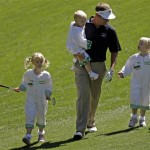 Stuart Appleby of Australia walks down the first fairway with his children during the Par 3 competition before the Masters golf tournament Wednesday, April 6, 2011, in Augusta, Ga. (AP Photo/Chris O'Meara)