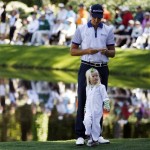 Henrik Stenson of Sweden and his daughter Lisa wait on the ninth green during the Par 3 competition before the Masters golf tournament Wednesday, April 6, 2011, in Augusta, Ga. (AP Photo/Matt Slocum)
