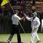 Justin Rose of England congratulates his caddie Mark Fulcher after Fulcher putted on the ninth hole during the Par 3 competition before the Masters golf tournament Wednesday, April 6, 2011, in Augusta, Ga. (AP Photo/Matt Slocum)
