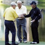Arnold Palmer, center, looks on as Jack Nicklaus, left, shakes hands with Gary Player on the ninth green during the Par 3 competition before the Masters golf tournament Wednesday, April 6, 2011, in Augusta, Ga. (AP Photo/Matt Slocum)