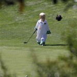 Stuart Appleby of Australia's son Max drags a golf club during the Par 3 competition before the Masters golf tournament Wednesday, April 6, 2011, in Augusta, Ga. (AP Photo/David J. Phillip)