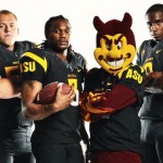 Sparky and players model new black football uniforms