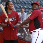 Cardinals WR Larry Fitzgerald takes some instruction from D-backs hitting coach Don Baylor during batting practice at Chase Field Tuesday, April 12, 2011. (Adam Green/Arizonasports.com)