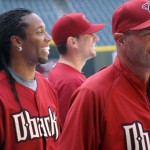 Cardinals WR Larry Fitzgerald shares a laugh with D-backs manager Kirk Gibson during batting practice at Chase Field Tuesday, April 12, 2011. (Adam Green/Arizonasports.com)