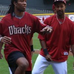 Cardinals WR Larry Fitzgerald stretches with D-backs centerfielder Chris Young before batting practice at Chase Field Tuesday, April 12, 2011. (Adam Green/Arizonasports.com)