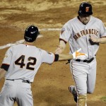 San Francisco Giants' Aubrey Huff is congratulated by Pat Burrell (42) after Huff scored on a wild pitch against the Arizona Diamondbacks during the fifth inning of a baseball game Friday, April 15, 2011, in Phoenix. (AP Photo/Matt York)