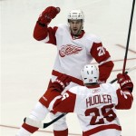 Detroit Red Wings' Drew Miller (20) celebrates his goal against the Phoenix Coyotes with teammate Jiri Hudler (26), of the Czech Republic, during the first period in Game 3 of a first-round series NHL Stanley Cup playoffs hockey game Monday, April 18, 2011, in Glendale, Ariz. (AP Photo/Ross D. Franklin)