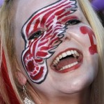 Nikki Otjen, of Peoria, Ariz., cheers for the Detroit Red Wings as fans gathered outside the arena prior to Game 4 of a first-round series NHL Stanley Cup playoffs hockey game between the Red Wings and the Phoenix Coyotes on Wednesday, April 20, 2011, in Glendale, Ariz. (AP Photo/Ross D. Franklin)