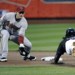 Arizona Diamondbacks shortstop Stephen Drew, left, prepares to tag New York Mets' Jose Reyes who was picked off of first base during the first inning of a baseball game Friday, April 22, 2011 at Citi Field in New York. (AP Photo/Bill Kostroun)
