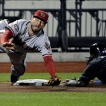 New York Mets' Jose Reyes, right, slides into third base on a passed ball as Arizona Diamondbacks third baseman Ryan Roberts attempts to catch the throw during the eighth inning of a baseball game Friday, April 22, 2011 at Citi Field in New York. (AP Photo/Bill Kostroun)