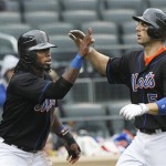 New York Mets' David Wright, right, celebrates with teammate Jose Reyes, after both scored on a Jason Bay single during the first inning of a baseball game against the Arizona Diamondbacks Saturday, April 23, 2011, at CitiField in New York. (AP Photo/Frank Franklin II)