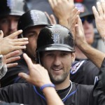 New York Mets' Jason Pridie is surrounded by hands in the Mets' dugout after his three-run home run against the Arizona Diamondbacks in the third inning of a baseball game in New York, Sunday, April 24, 2011. (AP Photo/Paul J. Bereswill)
