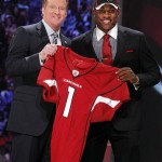 LSU cornerback Patrick Peterson holds up a jersey with NFL commissioner Roger Goodell after he was selected as the fifth overall pick by the Arizona Cardinals in the first round of the NFL football draft at Radio City Music Hall Thursday, April 28, 2011, in New York. (AP Photo/Jason DeCrow)
