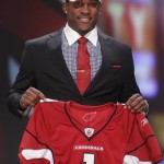 LSU cornerback Patrick Peterson holds up a jersey after he was selected as the fifth overall pick by the Arizona Cardinals in the first round of the NFL football draft at Radio City Music Hall Thursday, April 28, 2011, in New York.(AP Photo/Jason DeCrow)