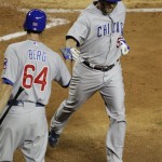 Chicago Cubs' Koyie HIll is greeted at home plate by teammate Justin Berg (64) after Hill hit a solo home run against the Arizona Diamondbacks during the third inning of a baseball game, Thursday, April 28, 2011, in Phoenix. (AP Photo/Matt York)