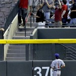 A fan can't catch a grand slam home run off the bat of Arizona Diamondbacks' Stephen Drew as Chicago Cubs' Kosuke Fukudome (1) looks on during the first inning of a baseball game, Thursday, April 28, 2011, in Phoenix. (AP Photo/Matt York)