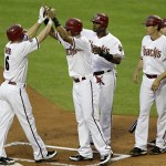 From Left; Arizona Diamondbacks' Stephen Drew (6) high fives teammates Chris Young, Justin Upton and Kelly Johnson after hitting a grand slam against the Chicago Cubs during the first inning of a baseball game, Thursday, April 28, 2011, in Phoenix. (AP Photo/Matt York)
