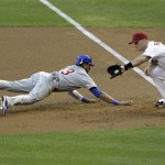 Chicago Cubs' Starlin Castro dives back on a pick-off attempt as Arizona Diamondbacks' Branyan makes the catch during the first inning of a baseball game, Thursday, April 28, 2011, in Phoenix. (AP Photo/Matt York)