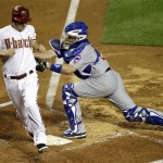 Arizona Diamondbacks' Stephen Drew, left, scores around the reach of Chicago Cubs catcher Koyie Hill during the second inning of a baseball game on an RBI double by Miguel Montero Thursday, April 28, 2011, in Phoenix. (AP Photo/Matt York)