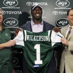 New York Jets head coach Rex Ryan, left, and GM Mike Tannenbaum, right, smile as they hold on to a jersey as they introduce their first round draft pick Muhammad Wilkerson at the team's training facility, Friday, April 29, 2011, in Florham Park, N.J. The Jets selected the Temple defensive lineman with the 30th overall pick in the NFL draft. (AP Photo/Mel Evans)