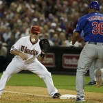 Arizona Diamondbacks' Russell Branyan, left, waits for the ball to arrive for an out as Chicago Cubs' Carlos Zambrano (38) runs toward first base in the fifth inning during an MLB baseball game Friday, April 29, 2011, in Phoenix. (AP Photo/Ross D. Franklin)