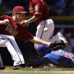 Arizona Diamondbacks' Stephen Drew, left, is unable to come up with the ball as Chicago Cubs' Alfonso Soriano (12) slides into third base on an infield groundout by Marlon Byrd during the second inning of a baseball game Sunday, May 1, 2011, in Phoenix. (AP Photo/Ross D. Franklin)