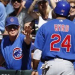 Chicago Cubs' Mike Quade, left, congratulates Marlon Byrd (24) after Byrd scored against the Arizona Diamondbacks during the seventh inning of a baseball game Sunday, May 1, 2011, in Phoenix. The Diamondbacks defeated the Cubs 4-3. (AP Photo/Ross D. Franklin)