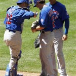 Chicago Cubs' Casey Coleman, middle, gets some encouragement from teammates Geovany Soto, left, and Carlos Pena, after a wild pitch by Coleman during the fourth inning in a baseball game against the Arizona Diamondbacks on Sunday, May 1, 2011, in Phoenix. The Diamondbacks defeated the Cubs 4-3. (AP Photo/Ross D. Franklin)