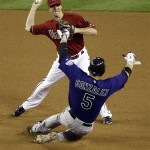 Colorado Rockies' Carlos Gonzalez (5) is forced out by Arizona Diamondbacks' Josh Wilson who turns a double play during the seventh inning of a baseball game on Wednesday, May 4, 2011, in Phoenix. (AP Photo/Matt York)