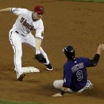 Colorado Rockies' Ian Stewart (9) gets tagged out trying to reach second base on a sacrifice fly that scored a run, as Arizona Diamondbacks' Stephen Drew waits to apply the tag during the second inning of an MLB baseball game, Thursday, May 5, 2011, in Phoenix. (AP Photo/Ross D. Franklin)