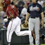 Atlanta Braves' Chipper Jones, right, watches as Arizona Diamondbacks' Justin Upton rounds third after hitting a solo home run during the first inning of a baseball game on Wednesday, May 18, 2011, in Phoenix. (AP Photo/Matt York)