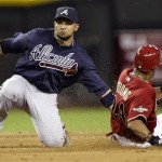 Atlanta Braves' Alex Gonzalez, left, tags out Arizona Diamondbacks' Chris Young on a steal-attempt during the fifth inning of a baseball game on Wednesday, May 18, 2011, in Phoenix. (AP Photo/Matt York)
