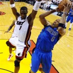 Dallas Mavericks' Shawn Marion (0) puts up a shot with Miami Heat's Chris Bosh (1) defending during the first half of Game 1 of the NBA Finals basketball game Tuesday, May 31, 2011, in Miami. (AP Photo/Larry W. Smith, Pool)