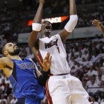 Miami Heat's Chris Bosh (1) goes for a basket as Dallas Mavericks' Tyson Chandler (6) defends during the first half of Game 1 of the NBA Finals basketball game Tuesday, May 31, 2011, in Miami. (AP Photo/Lynne Sladky)
