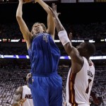 Dallas Mavericks' Dirk Nowitzki (41) goes up for a shot against Miami Heat's Chris Bosh (1) during the first half of Game 1 of the NBA Finals basketball game Tuesday, May 31, 2011, in Miami. (AP Photo/David J. Phillip; Pool)