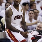 Miami Heat's LeBron James (6) sits on the scorers table during the first half of Game 1 of the NBA Finals basketball game against the Dallas Mavericks, Tuesday, May 31, 2011, in Miami. (AP Photo/David J. Phillip)
