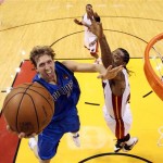 Dallas Mavericks' Dirk Nowitzki shoots over Miami Heat's Udonis Haslem during the first half of Game 1 of the NBA Finals basketball game Tuesday, May 31, 2011, in Miami. (AP Photo/Mike Ehrmann; Pool)
