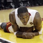 Miami Heat's Chris Bosh reacts on the floor after colliding with Dallas Mavericks' Dirk Nowitzki during the second half of Game 1 of the NBA Finals basketball game Tuesday, May 31, 2011, in Miami. (AP Photo/David J. Phillip)