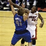 Miami Heat's Udonis Haslem (40) blocks a shot to the basket by Dallas Mavericks' Dirk Nowitzki (41) during the second half of Game 1 of the NBA Finals basketball game Tuesday, May 31, 2011, in Miami. (AP Photo/David J. Phillip)
