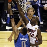 Miami Heat's Joel Anthony (50) blocks a shot to the basket by Dallas Mavericks' Shawn Marion (0) as Dirk Nowitzki watches during the second half of Game 1 of the NBA Finals basketball game Tuesday, May 31, 2011, in Miami. (AP Photo/David J. Phillip)